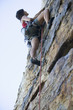 A climber climbing a rock face