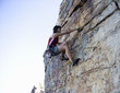 A climber climbing a rock face