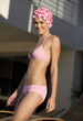 A woman in a bikini and swimming hat
