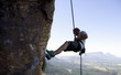 A climber climbing a rock face