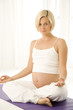 A pregnant woman practicing yoga