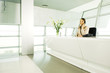 A receptionist talking on the telephone