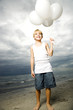 A young boy with a bunch of balloons