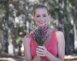 A young woman holding a bouquet of flowers