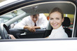 A young woman sitting in a new car