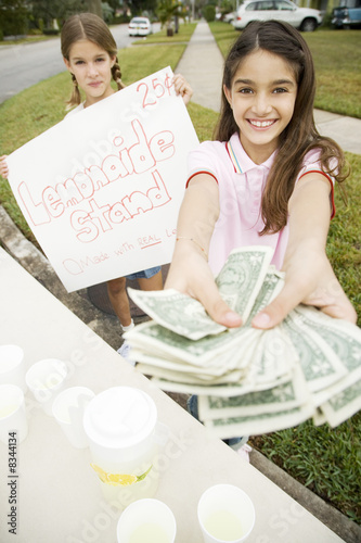 Photo: Two young girls at a lemonade stand Two young girls at a lemonade stand