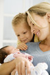 A mother and her son with a new baby