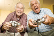 Two elderly men playing a video game