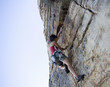 A climber climbing a rock face