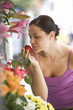 A young woman looking at a flower stall