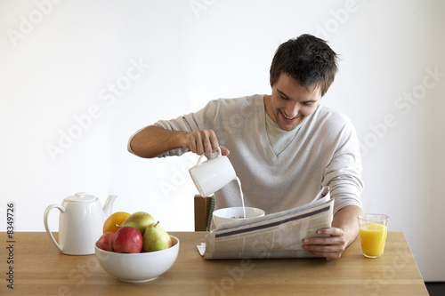 Photo: Young man having breakfast Young man having breakfast