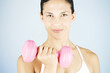 A young woman lifting weights