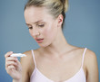 A young woman looking at a pregnancy test