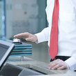 A businessman ringing a bell for attention