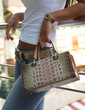 Woman posing with a mock croc bag Woman posing with a mock croc bag