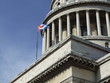 Havana's Capitol front corner and a flag