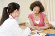 Woman in doctor's office frowning Woman in doctor's office frowning