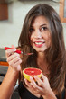 Sexy brunette eating breakfast