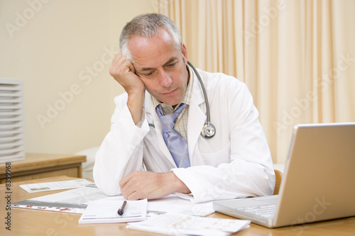 Photo: Doctor with laptop in doctor's office Doctor with laptop in doctor's office