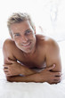 Man lying in bed smiling