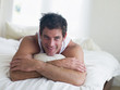 Man lying in bed smiling