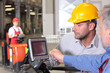 male inspector looking at screen with operator in warehouse