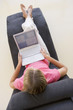 Woman sitting in chair using laptop