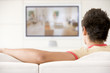 Man in living room watching television