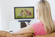 Woman in living room watching television