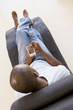 Man sitting in chair using personal digital assistant