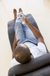 Man sitting in chair using remote control