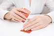 Woman peeping in under playing card