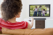 Woman in living room watching television