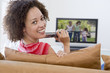 Woman in living room watching television