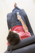 Man sitting in chair using remote control