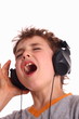Boy listening to music and singing Boy listening to music and singing