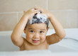 Little boy washing his hair in the tub Little boy washing his hair in the tub
