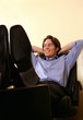 Young businessman relaxing with hands behind head