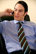 Young businessman sitting  and talking on cell phone