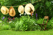 Summer straw hats hanging clothesline
