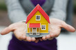 Woman holding a minature house