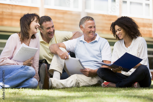 Photo: Adult students sitting on a campus lawn Adult students sitting on a campus lawn