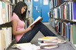 Photo: University student working in library University student working in library