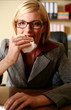  Young woman eating at her desk