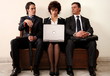  Three people sitting in a waiting room