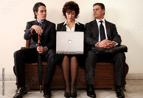Photo: Three people sitting in a waiting room Three people sitting in a waiting room