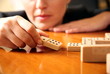  A woman playing with dominoes