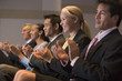 Photo: Five businesspeople applauding in presentation room Five businesspeople applauding in presentation room