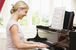 Woman playing piano and smiling Woman playing piano and smiling