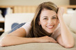 Photo: Woman lying in living room Woman lying in living room